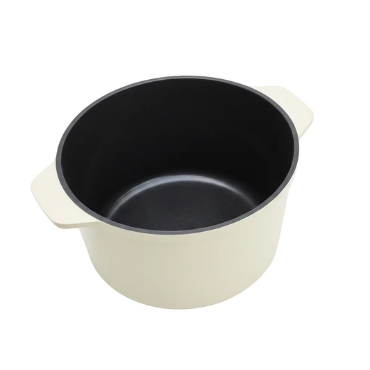 Black pot with beige handle and rim on a white background